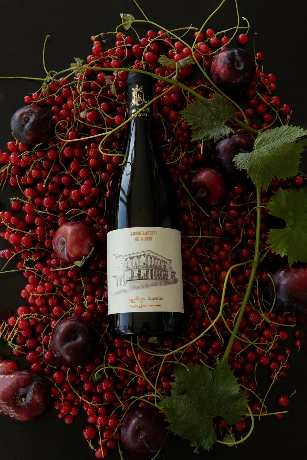 GK Winery bottle arranged with red berries and fruit