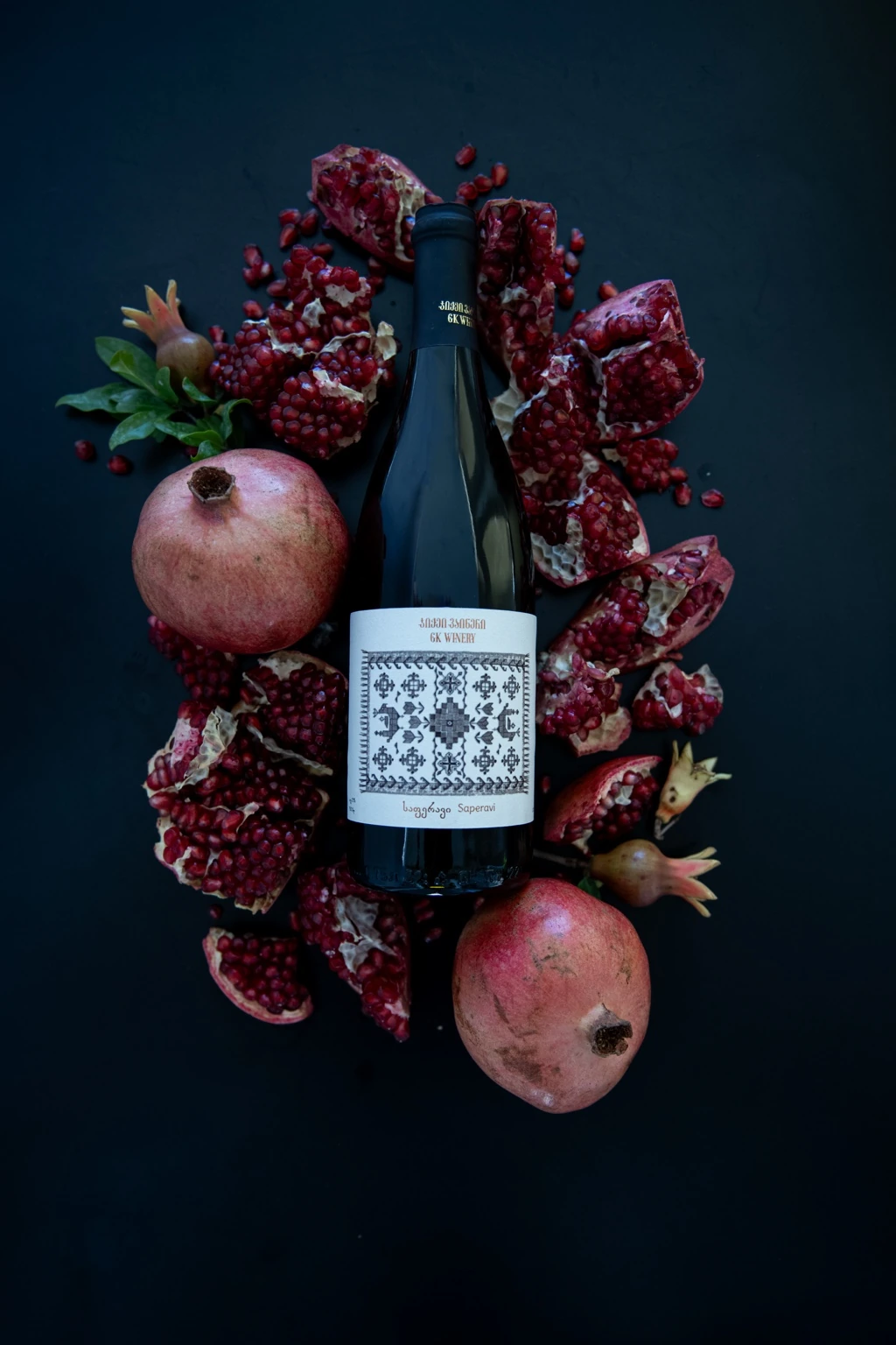 GK Winery bottle arranged with pomegranates