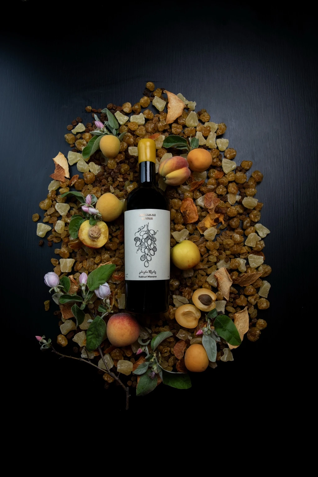 GK Winery bottle arranged with dried fruit and apples